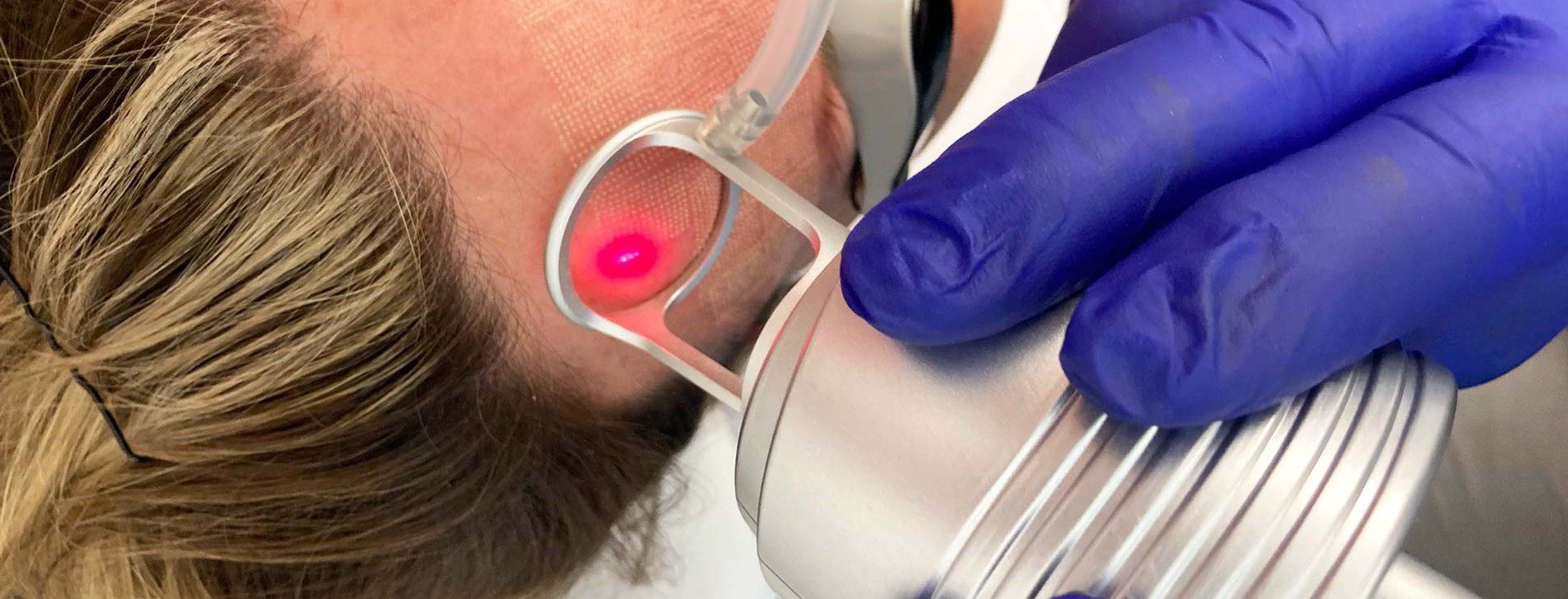 Woman having facial treatment with therapist