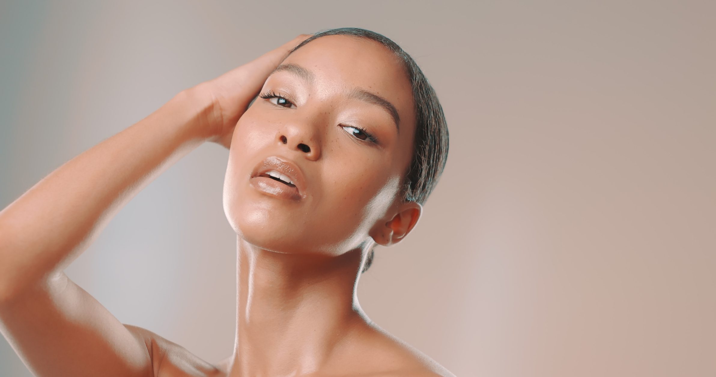 Studio shot of attractive woman posing with her hand in hair